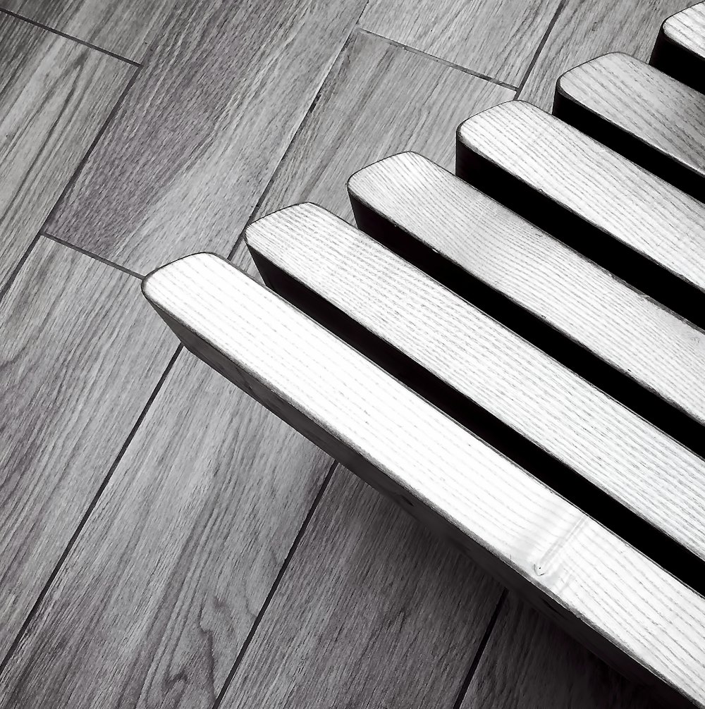 a wooden bench sitting on top of a hard wood floor