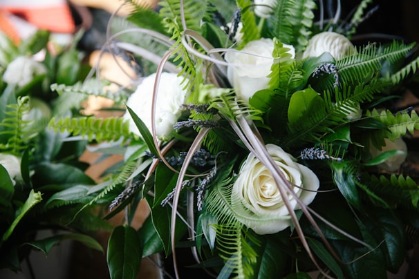 A sophisticated bouquet combining roses and greenery, styled with modern simplicity