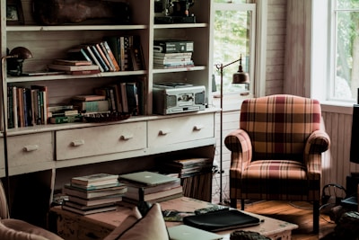 A cozy living room featuring a vintage wooden armchair and coffee table.
