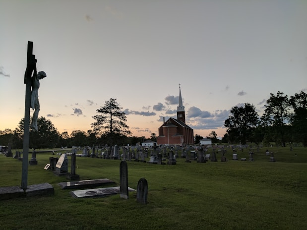 brown church near cemetery