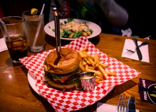 burger and fries served on plate