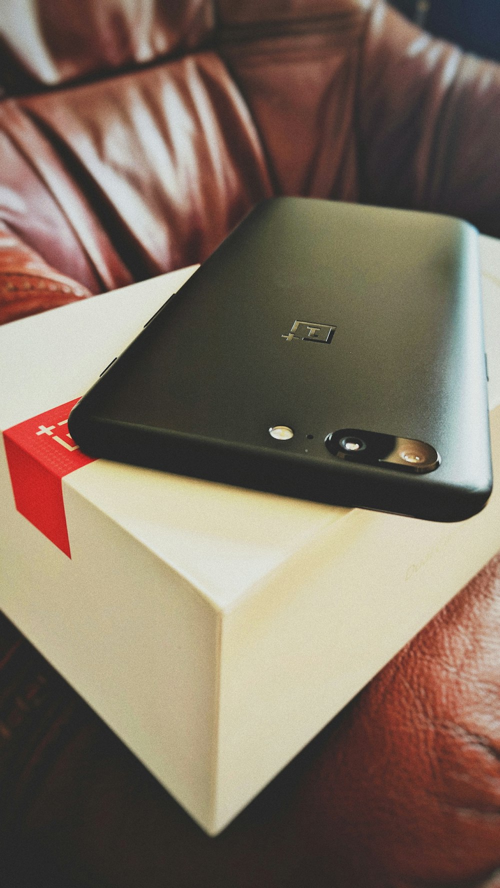 A black smartphone out of its box.
