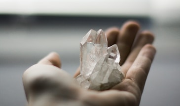 person holding crystal stones