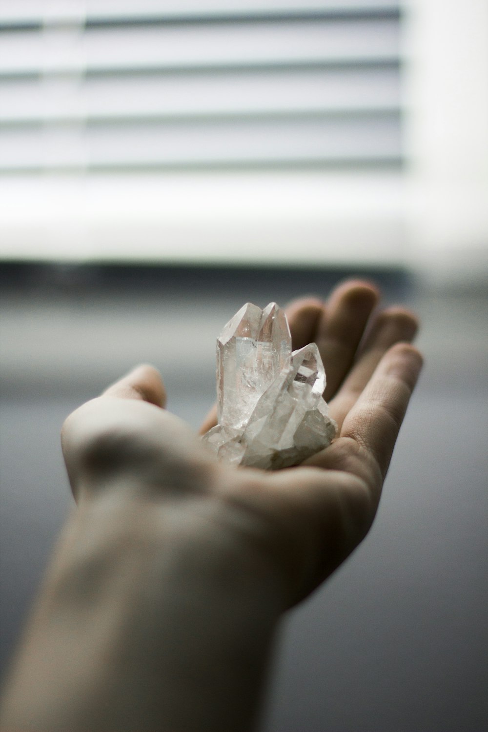 person holding crystal stones