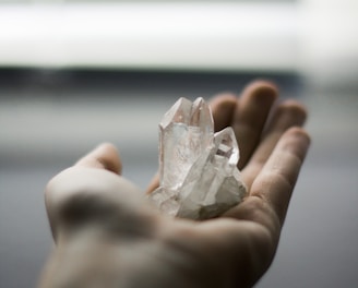 person holding crystal stones