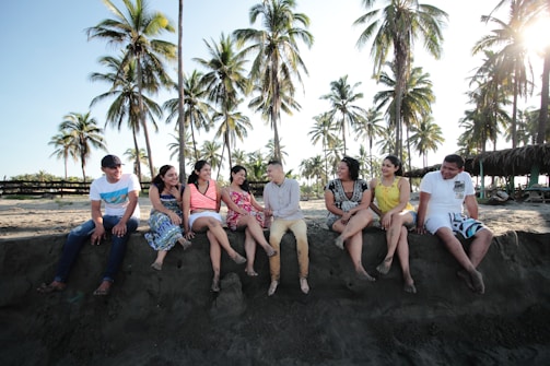 group of people sitting on san