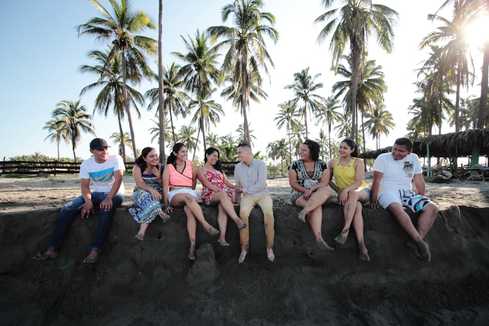 group of people sitting on san