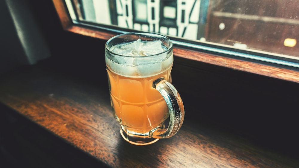 clear glass tankard with beverage