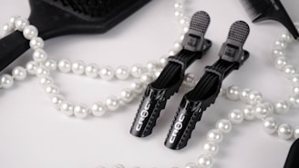 A flat lay of top-rated hair dryers and styling tools arranged neatly on a marble countertop.