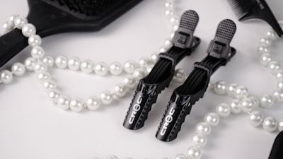 A stylish arrangement of refined hair accessories with soft natural lighting highlighting their details.