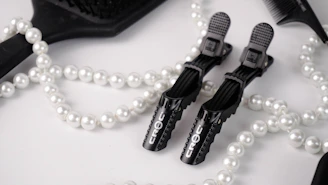 Elegant flat lay of luxurious hair care products with gold accents on a deep black background