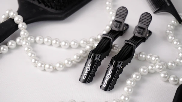 Elegant flat lay of hair care products and tools on a soft nude background, highlighting sophistication and care.