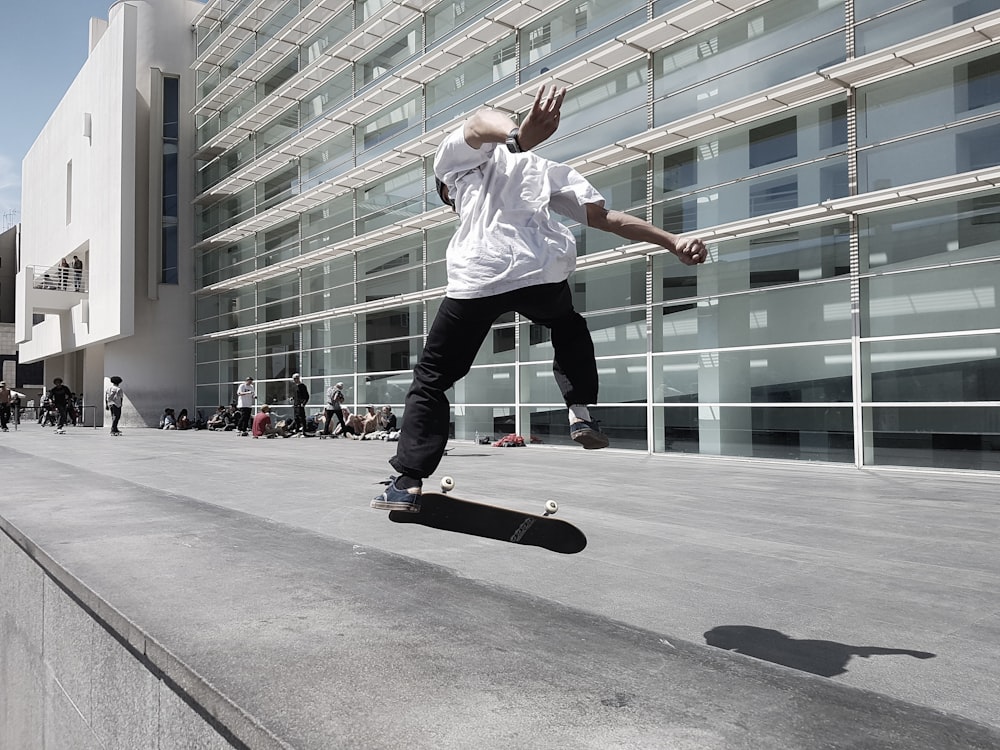 man skateboarding beside building during daytime