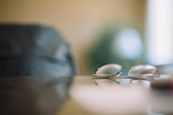 An elegant pair of eyeglasses resting on a soft fabric background.