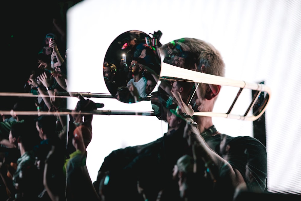 man playing trombone with white screen background