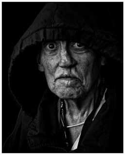grayscale photo of man wearing black jacket