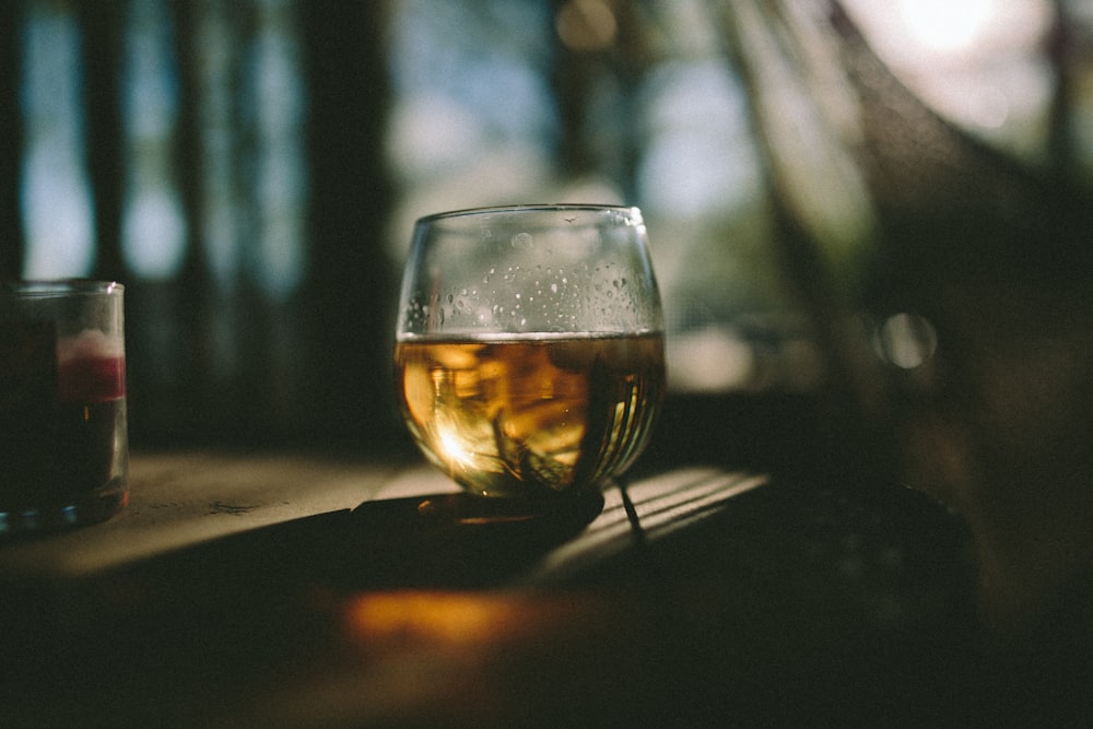 clear snifter glass on brown wooden table