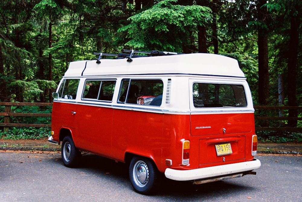 white and red van parked near trees