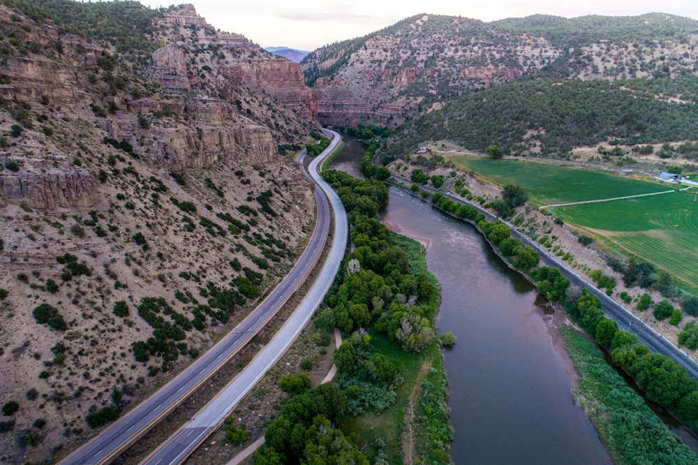 winding road near brown rocky mountain at daytime