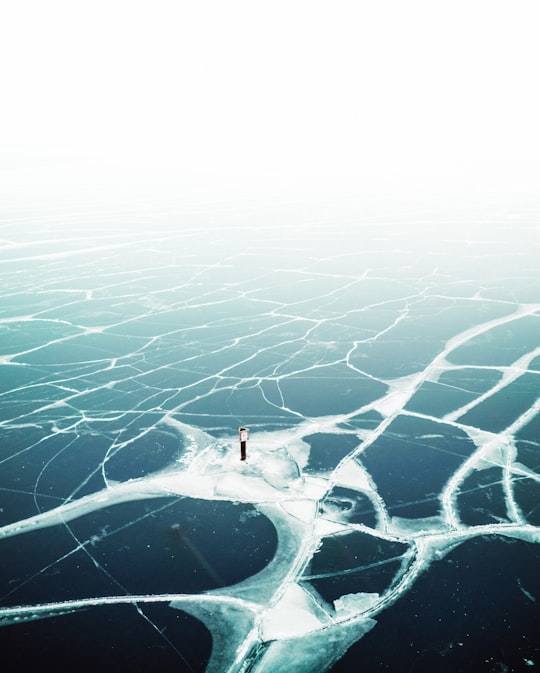 person standing on ice in Lake Michigan United States