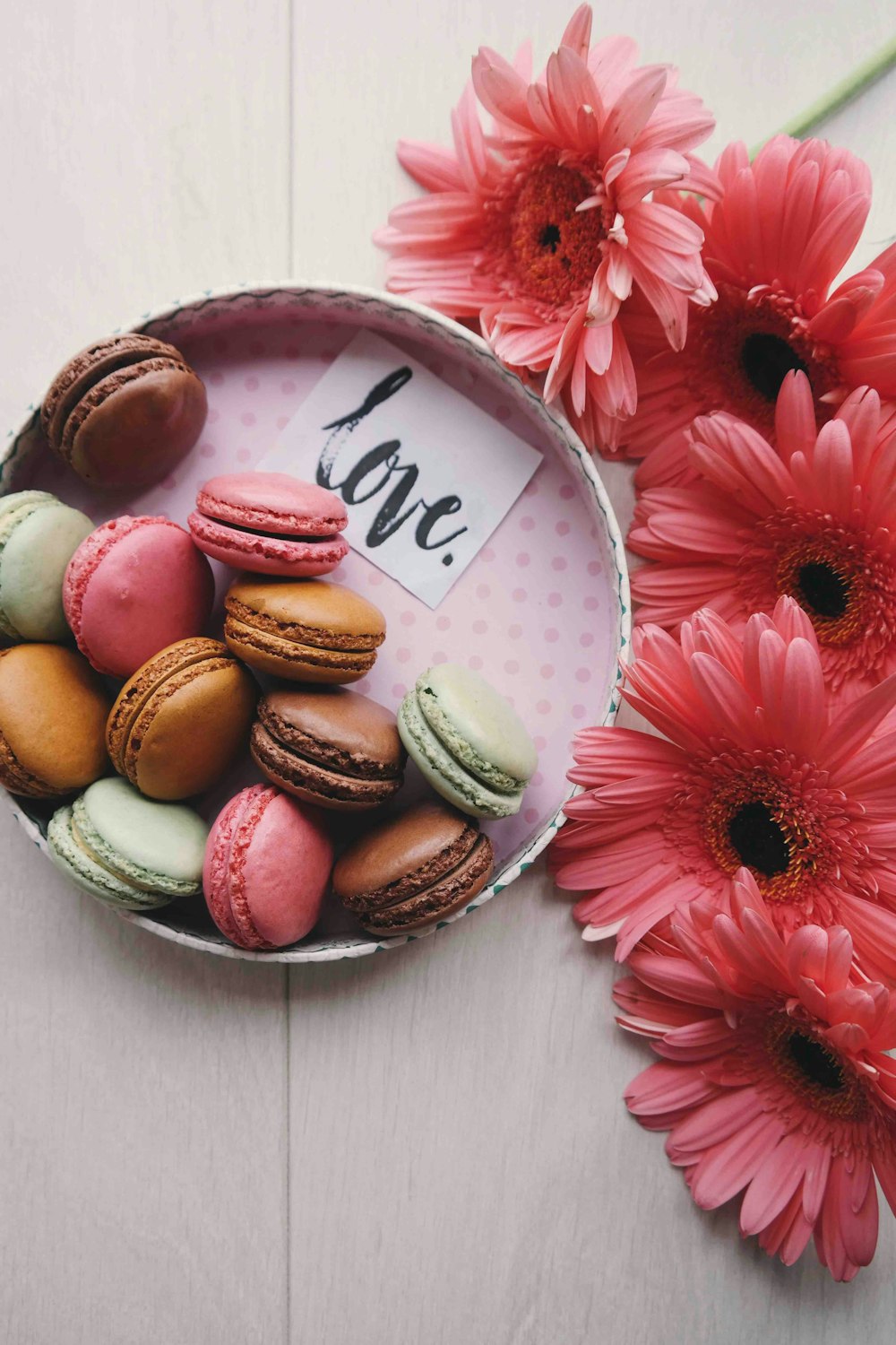 macaroons on a tray with the word 'love'