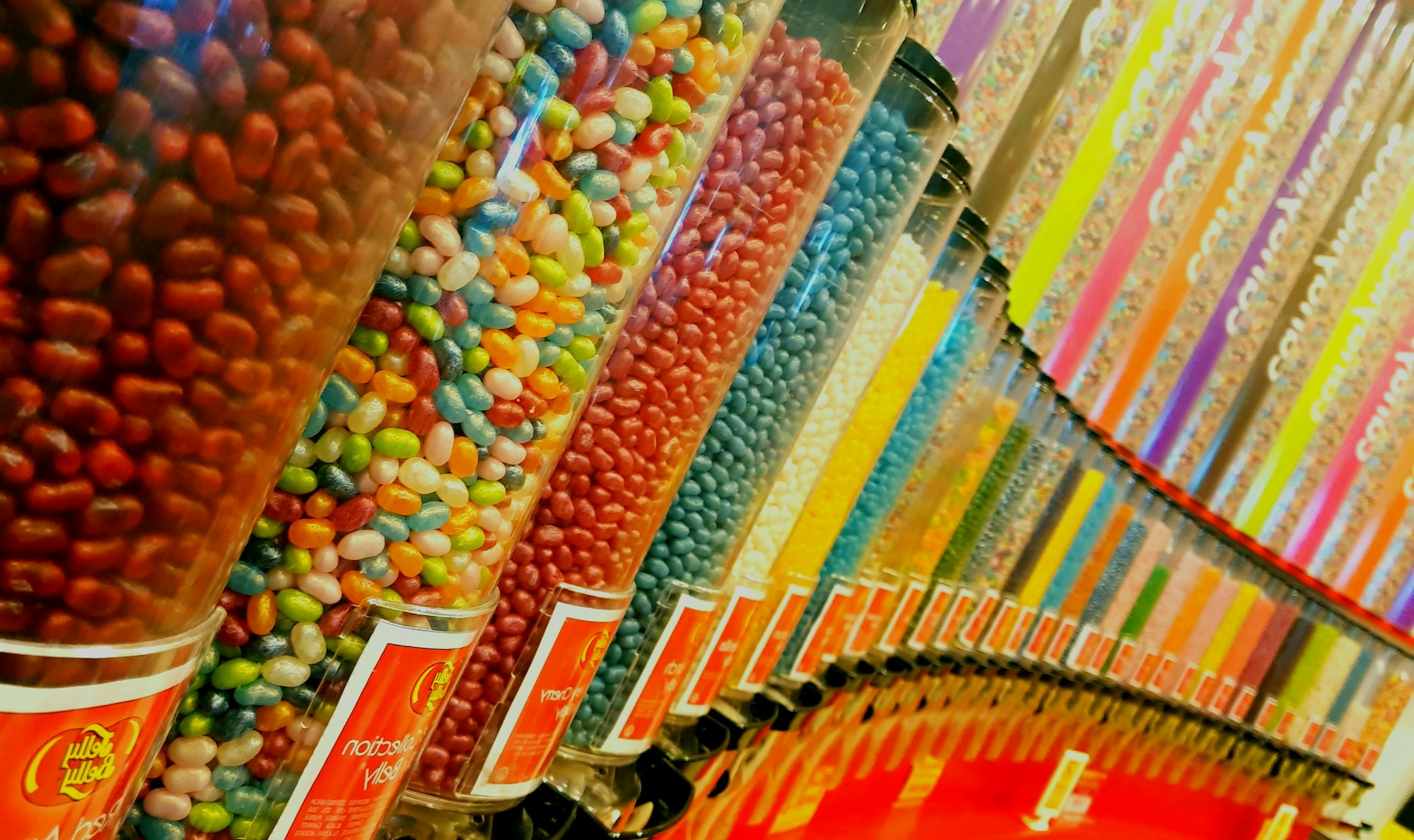 Rows of candy dispensers at a candy store.