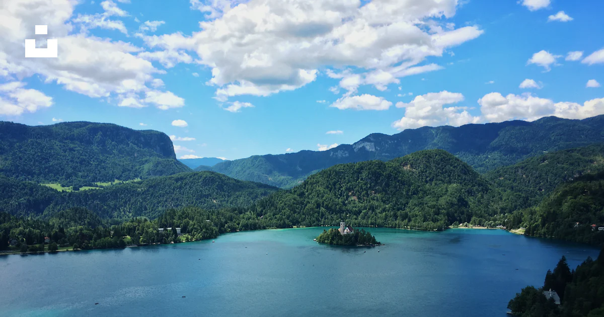 Turquoise and azur body of water surrounded by mountain range and ...