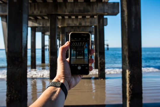 person holding black smartphone taking photo of sea during daytime in Coney Island United States