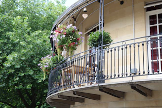 Elegant second-floor addition with modern balcony overlooking garden.