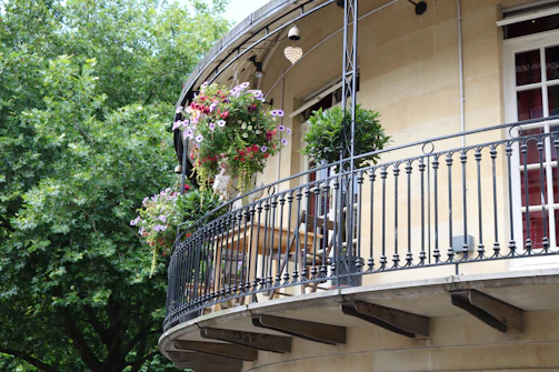 Elegant second-floor addition with modern balcony overlooking garden.