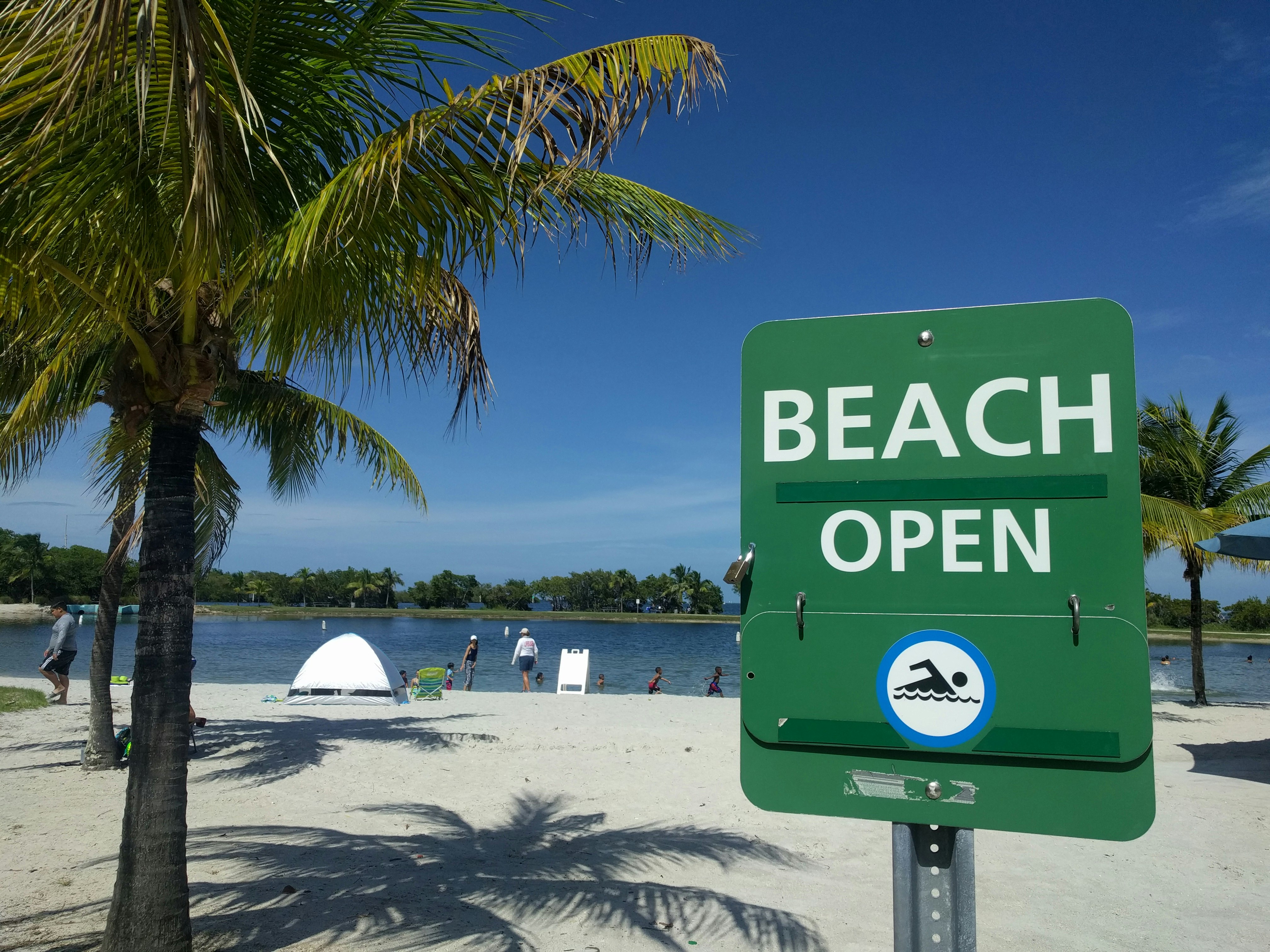 The sign says so much, but the beauty of the beach, the sand, the palms, it just calls you into the water.  Isn’t it time to go swimming at the beach.  Follow the sign, the beach is open and you need a good swim.  :)