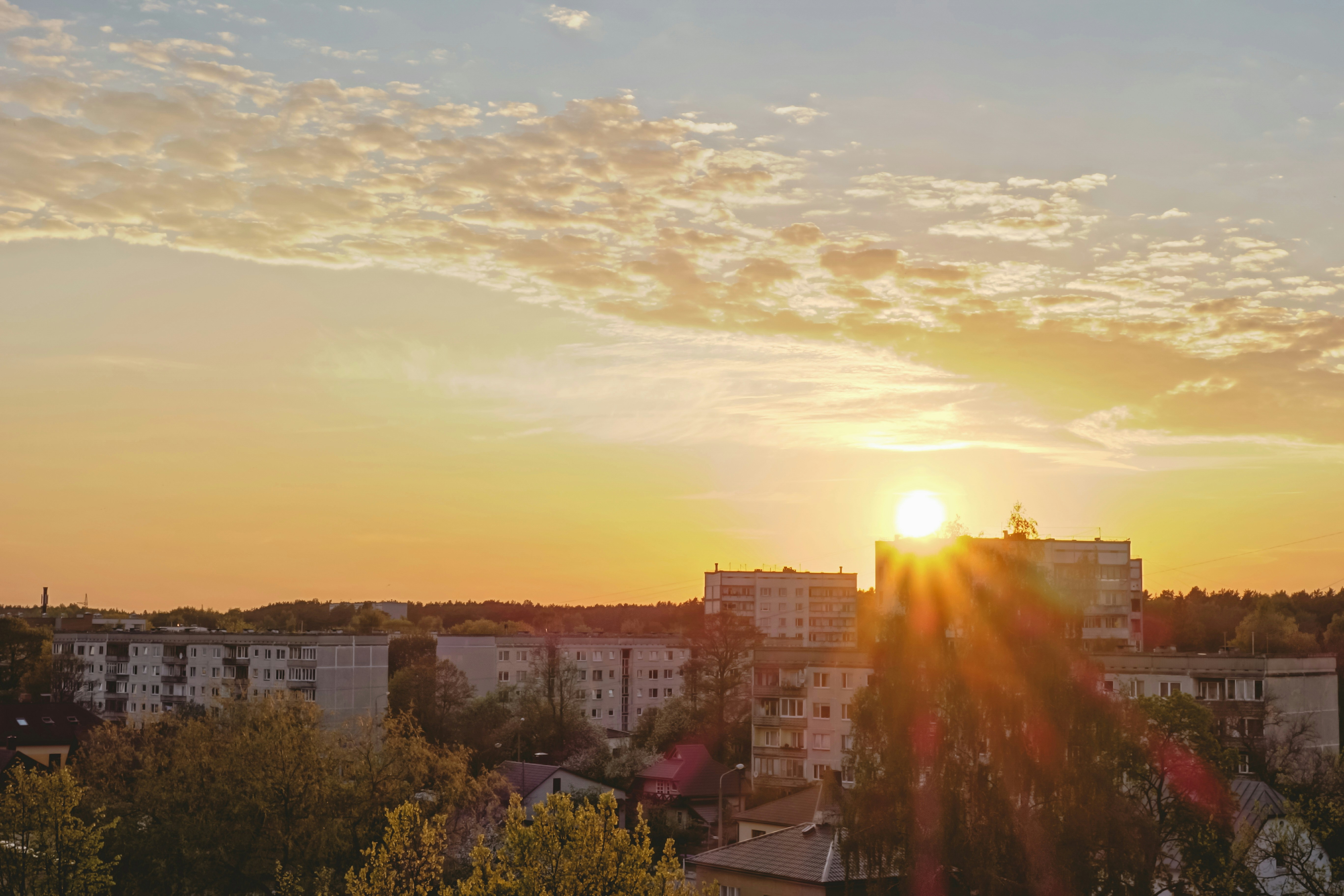 Sunset over Pretoria township, warm golden light, community streets in late afternoon