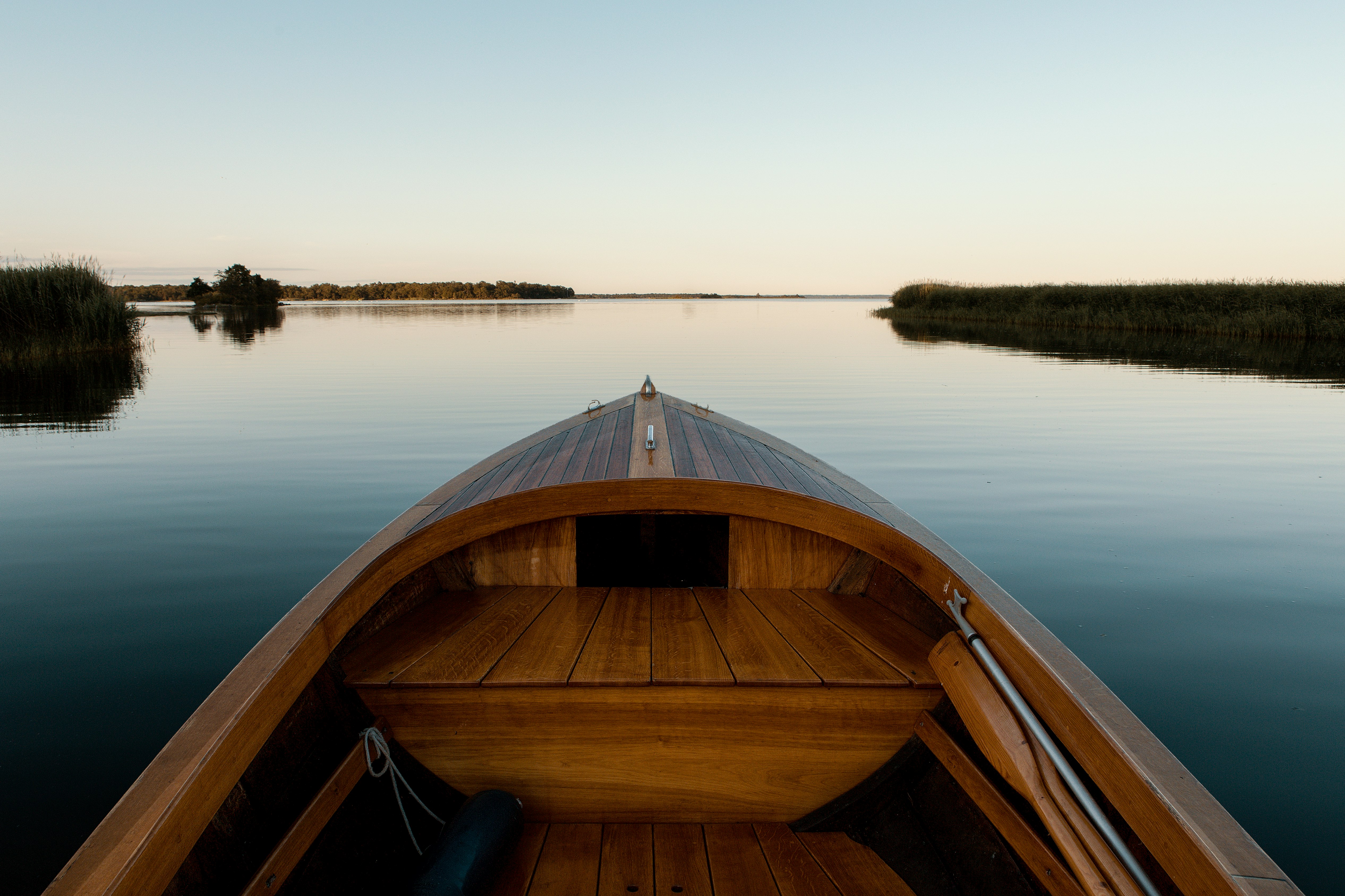 landscape photography of brown boat surrounded by body of water during daytime