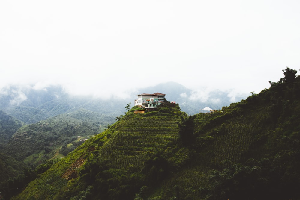 white concrete house on mountain during daytime