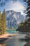 white mountain near body of water