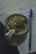 A traditional cup filled with yerba mate, accompanied by a metal straw. Next to it, a blue pen rests on open notebook pages that feature handwritten notes highlighted in neon yellow.