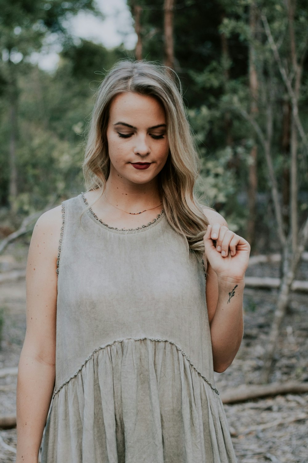 selective focus photography of woman holding her hair