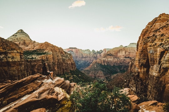 woman sitting on rock in Canyon Overlook United States