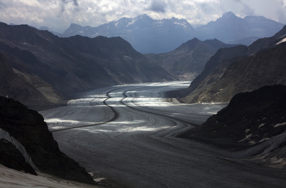 gray road surrounded with mountains