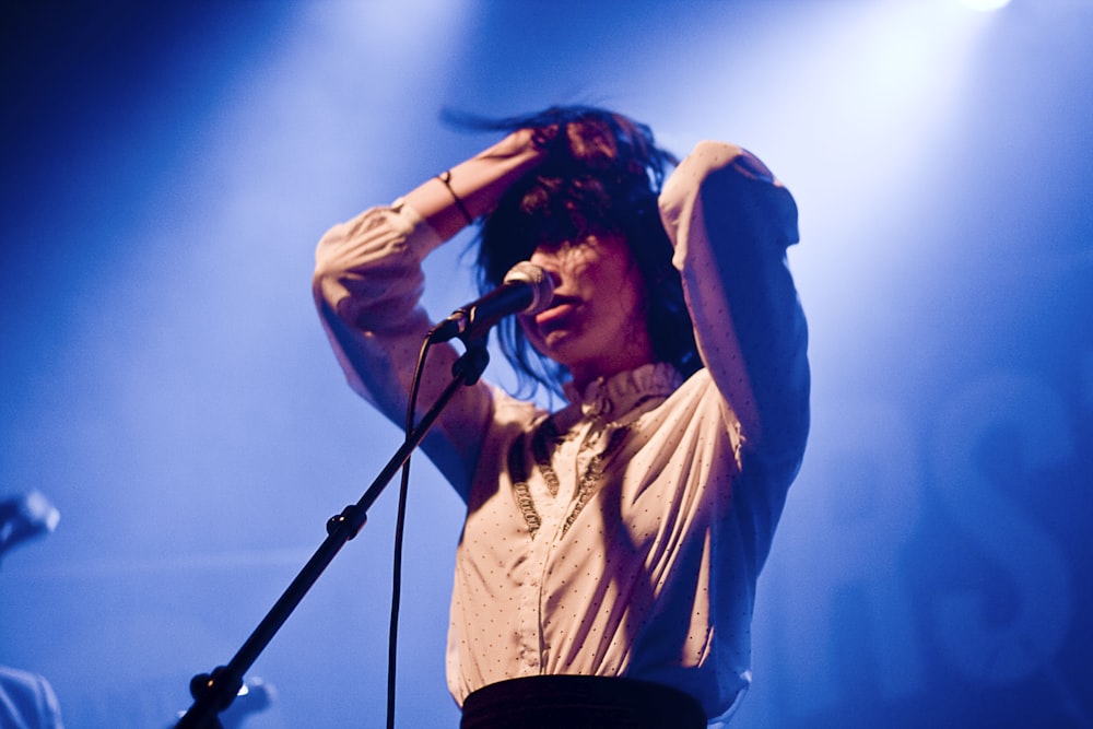 woman holding her hair in front of microphone