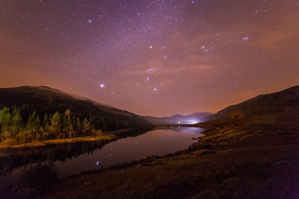 river between mountains during nighttime