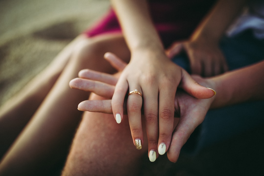 woman's hand placed on top of man's palm