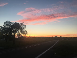 A serene landscape with a winding road leading into the distance.