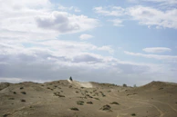 Sunlight filtering through dust clouds as motorcycles race across the sandy plains.