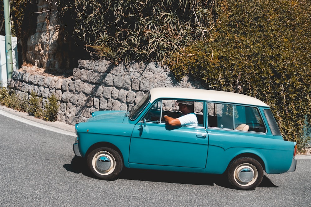 man riding teal vehicle