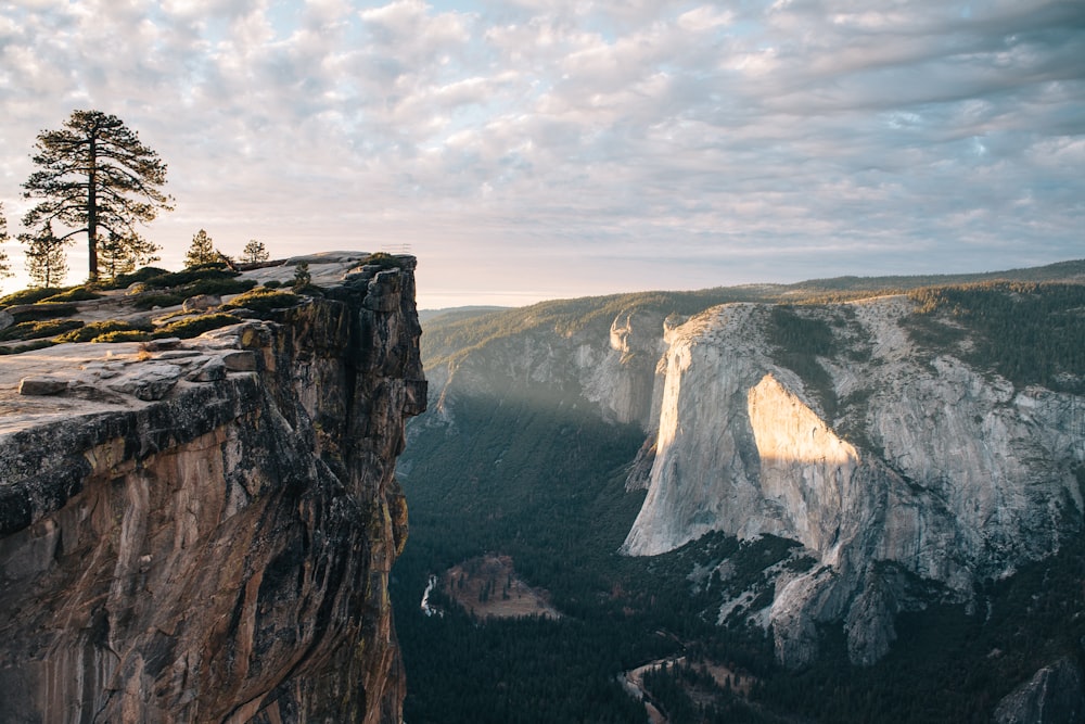 cliff overlooking mountain during daytime