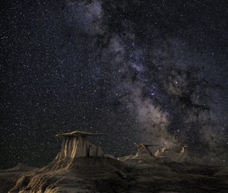 brown mountain under starry sky