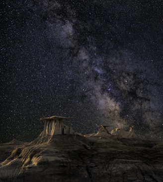 brown mountain under starry sky