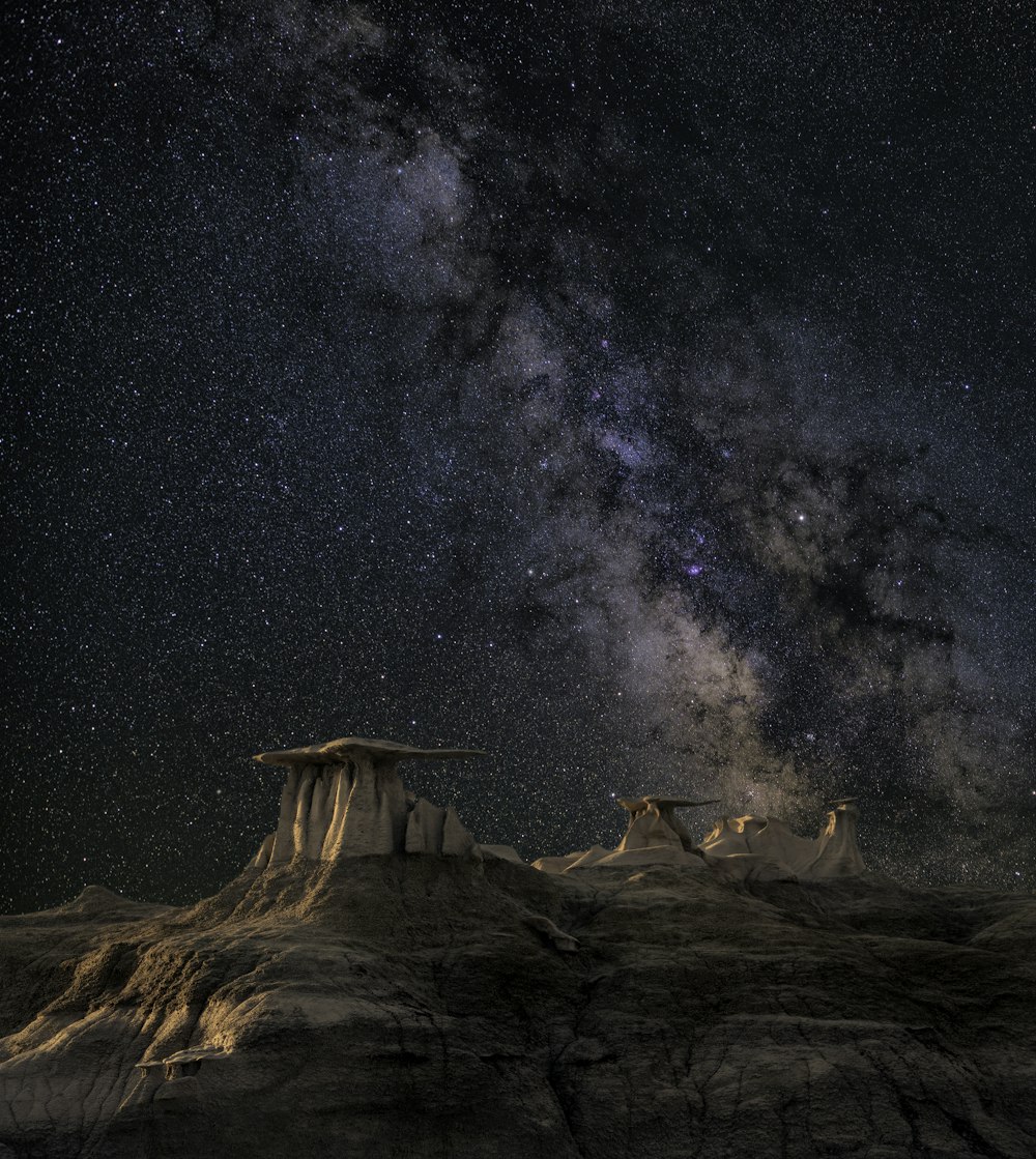 brown mountain under starry sky