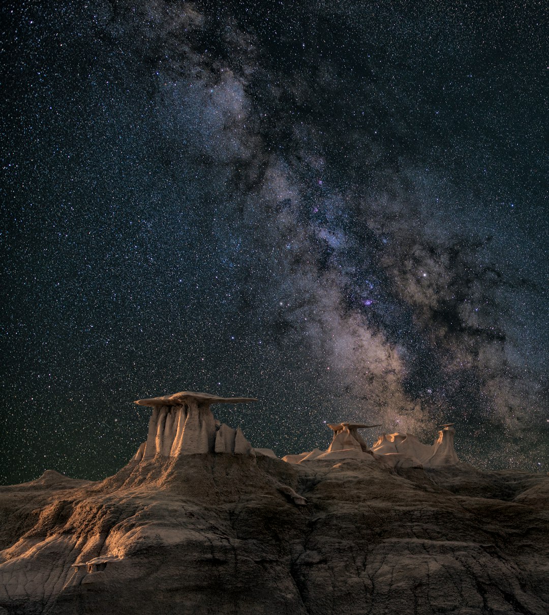 brown mountain under starry sky